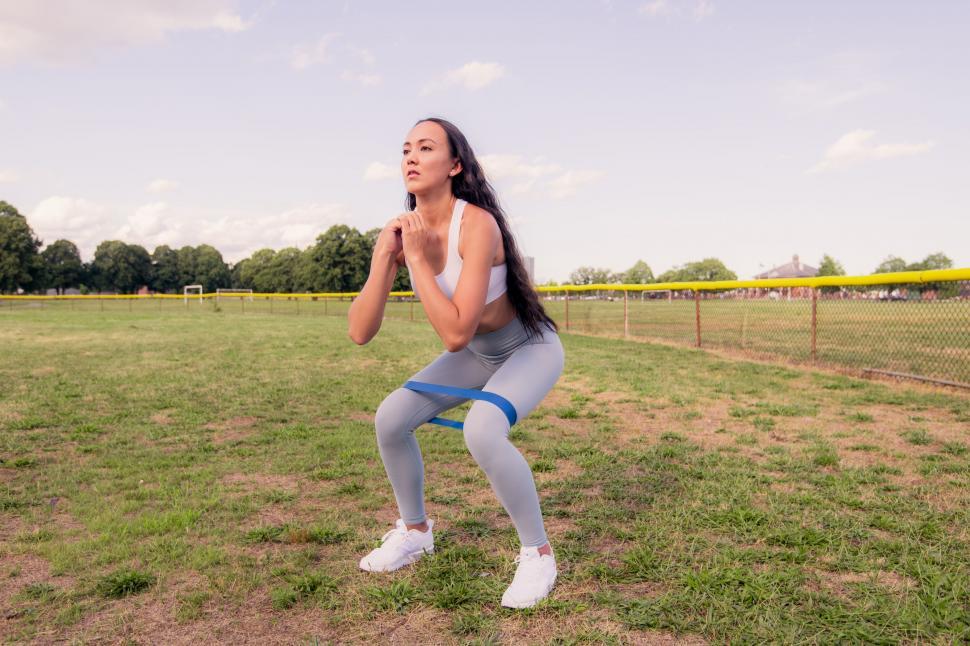 Free Image of Woman doing squats in outdoor setting 