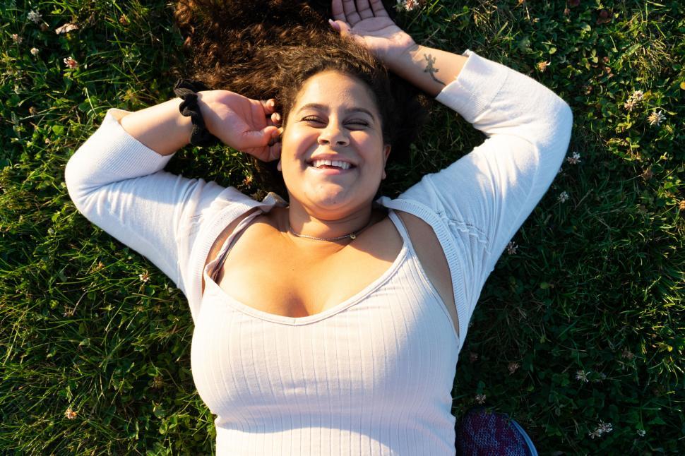 Free Image of Happy woman lying on grass 