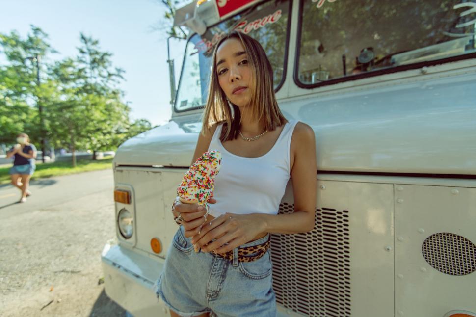Free Image of Woman holding ice cream near food truck 