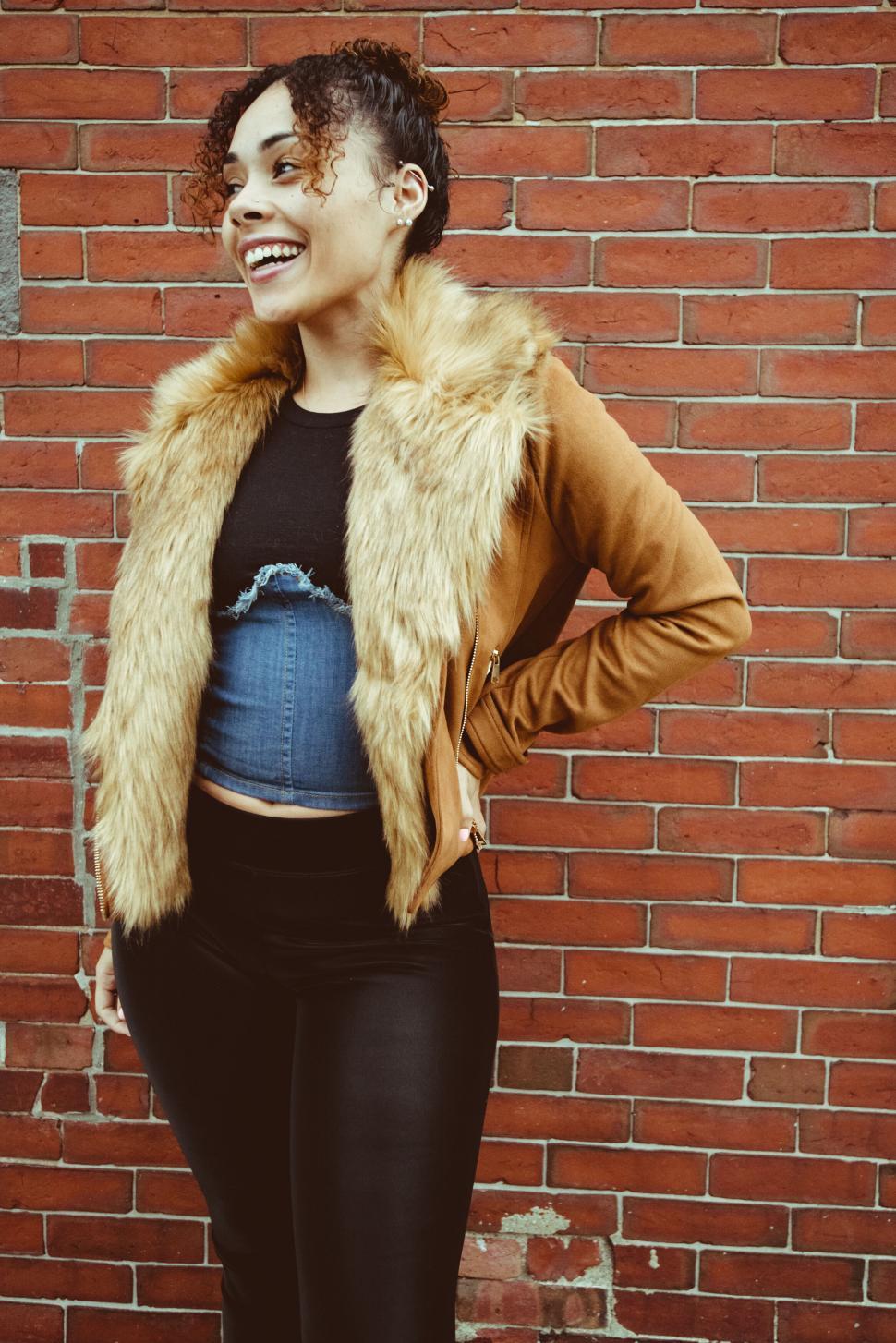 Free Image of Smiling woman with a trendy jacket 