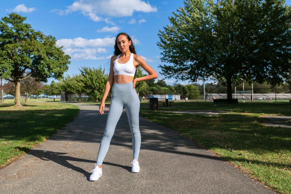 Free Image of Athletic woman posing in park wearing activewear 