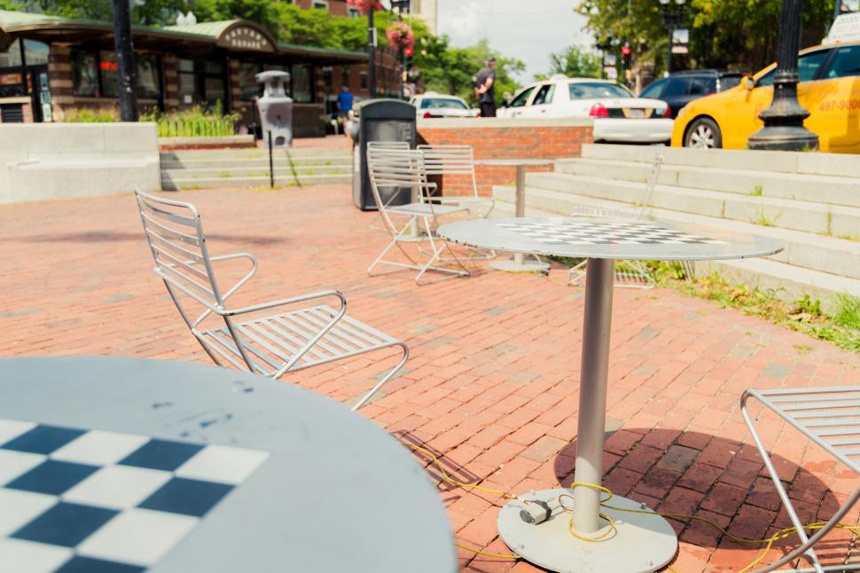 Free Image of Empty urban park area with tables and chairs 