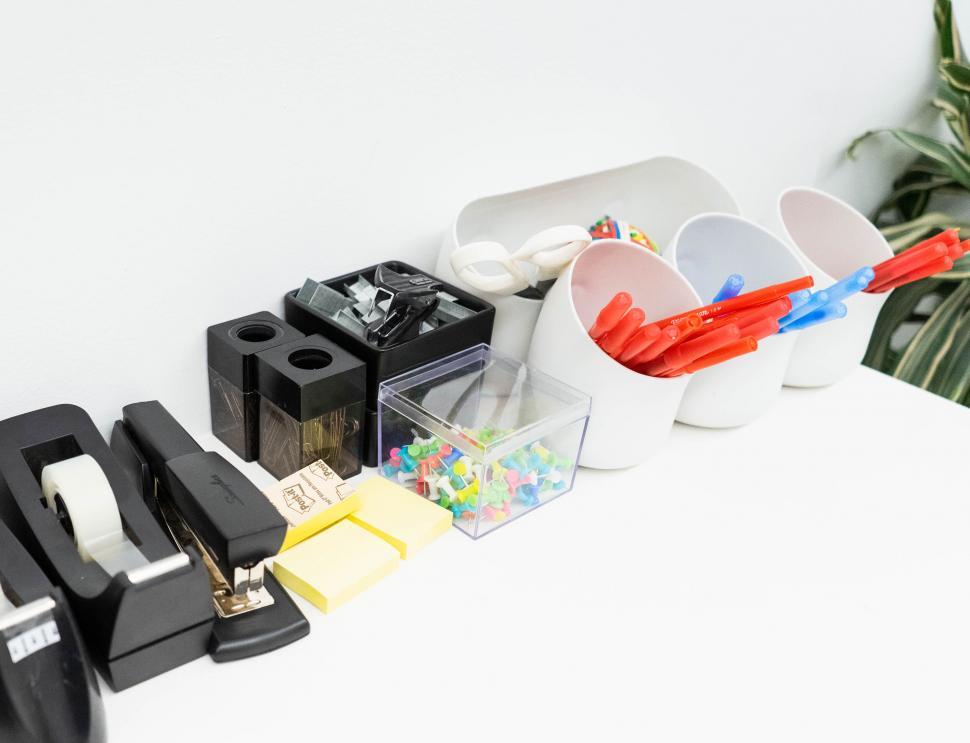 Free Image of Assorted office supplies on a white desk 