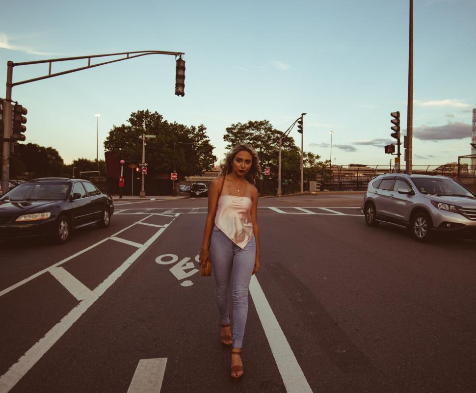 Free Image of Woman crossing street during twilight 
