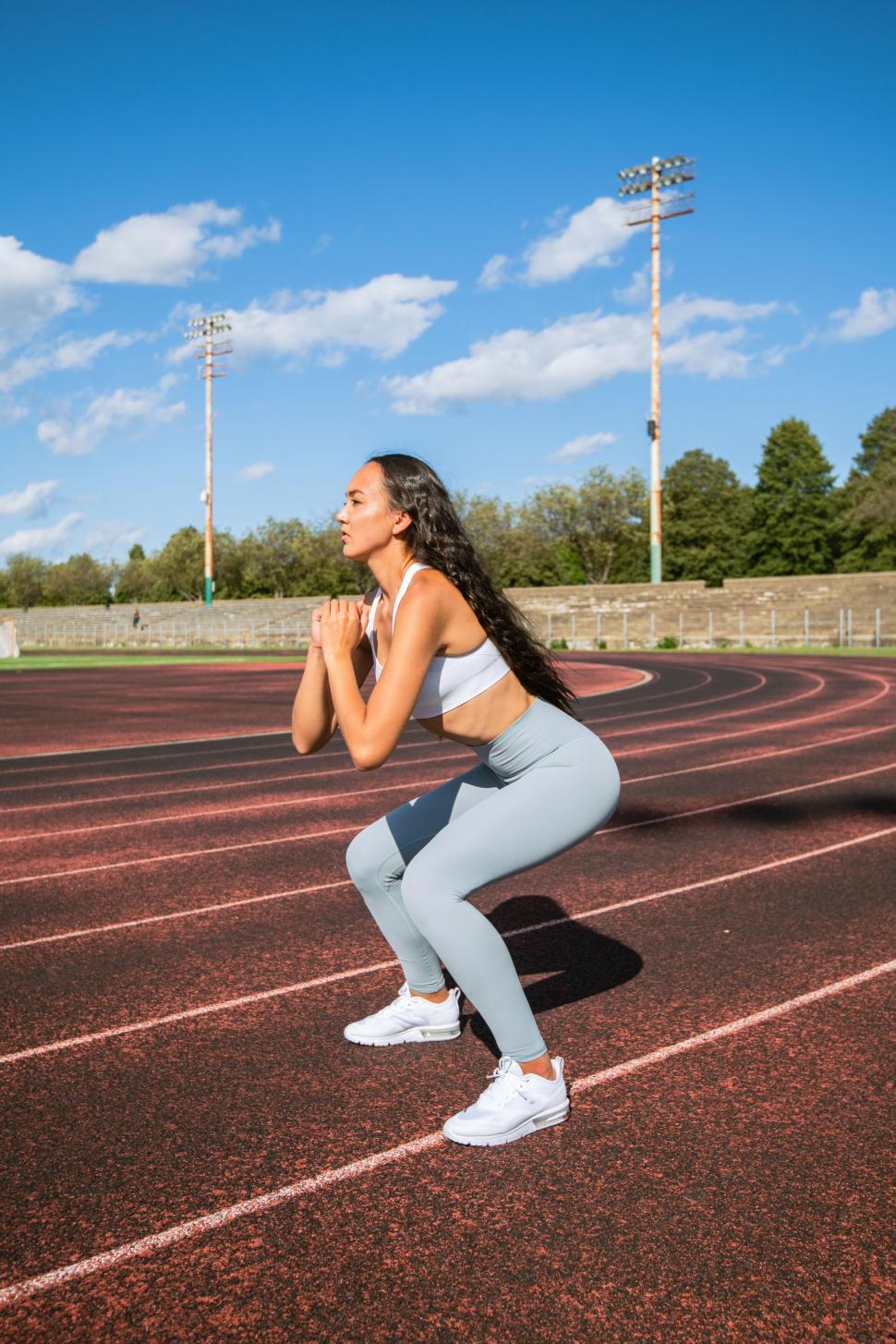 Free Image of Athletic woman in starting position on track 