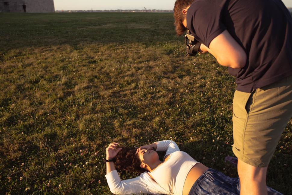Free Image of Photographer capturing a model in a field 