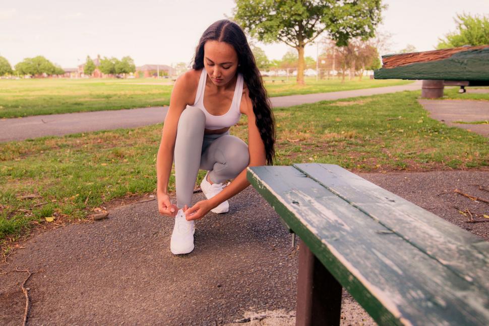 Free Image of Woman Tying Shoe Laces at Park 