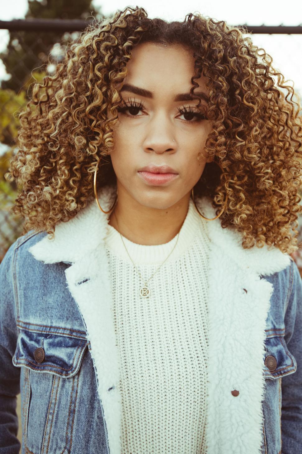 Free Image of Curly Haired Woman in Denim Jacket 