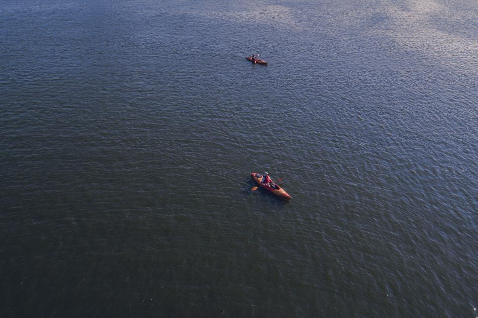 Free Image of Two kayaks floating on a serene lake 