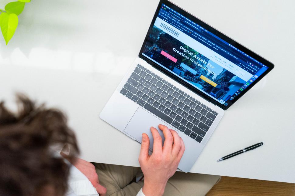 Free Image of Person working on laptop with website on screen 