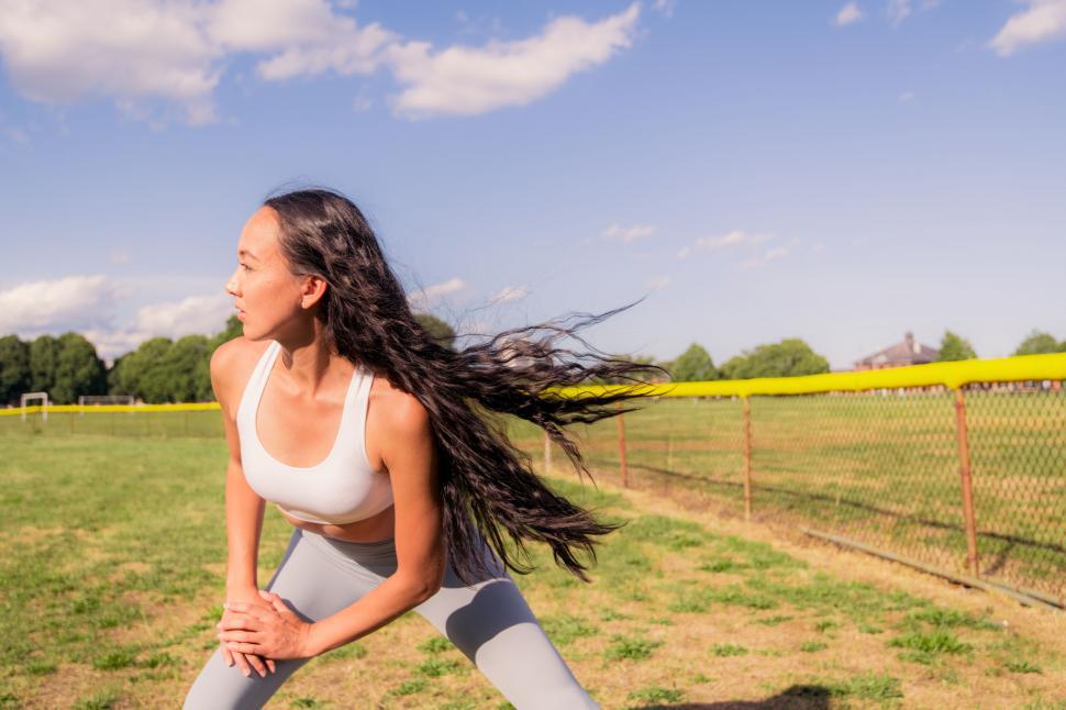 Free Image of Fitness woman stretching in sunny park 
