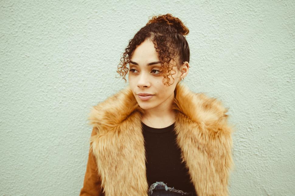 Free Image of Woman in faux fur coat and curls 