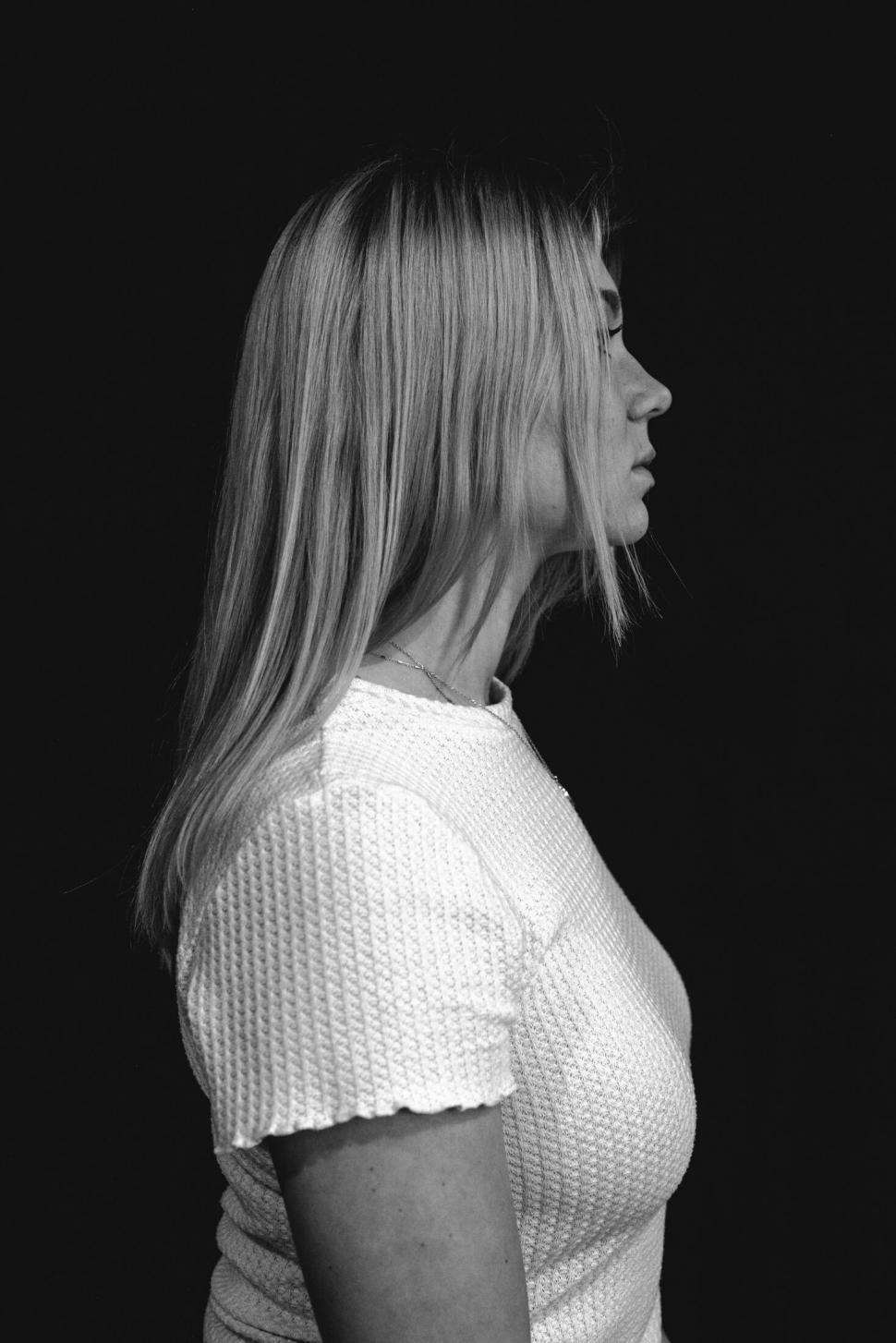 Free Image of Profile of a blonde woman in a white shirt 