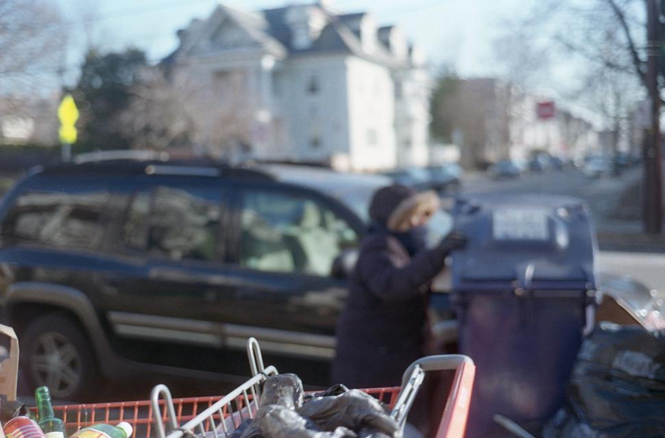 Free Image of Urban snapshot with person at trash can 