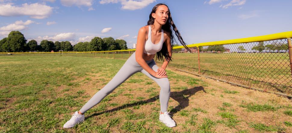 Free Image of Fitness woman stretching on field 