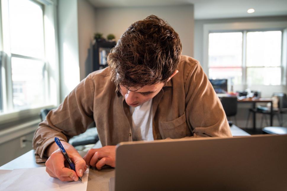 Free Image of Man working hard at desk in home office 