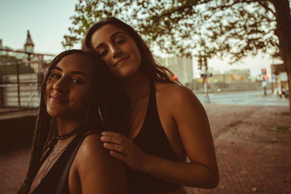 Free Image of Two women embracing on a city street 