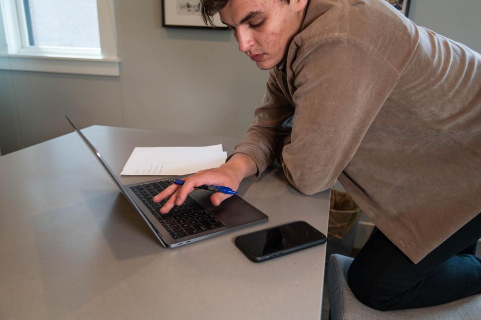 Free Image of Man working on laptop in a bright room 