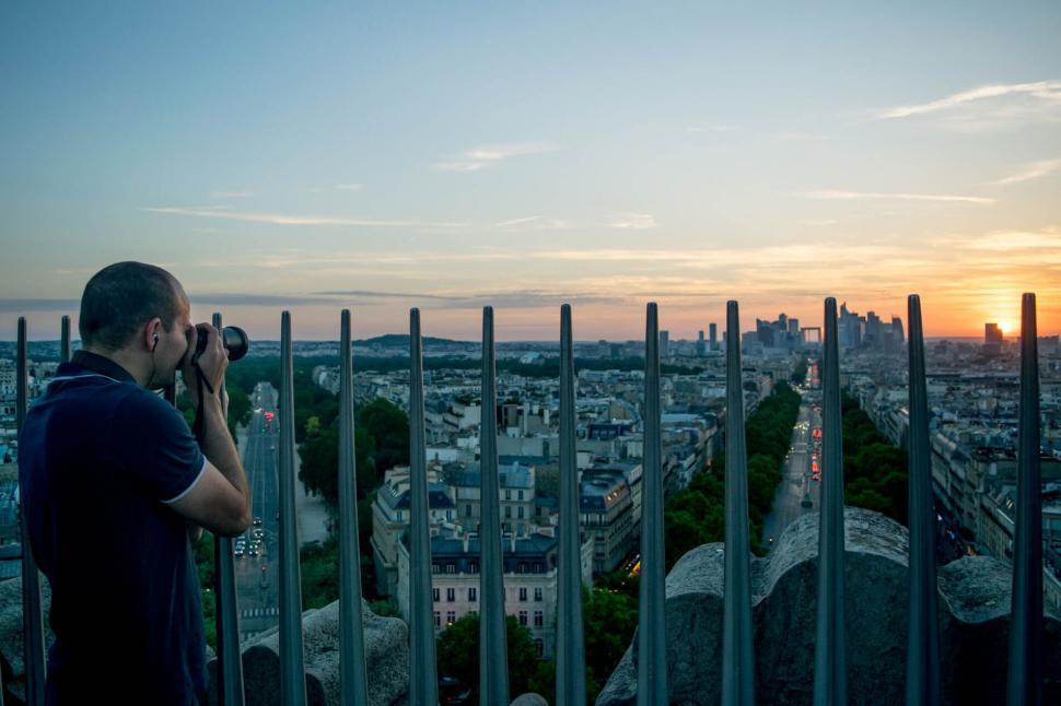 Free Image of Photographer capturing cityscape at sunrise 