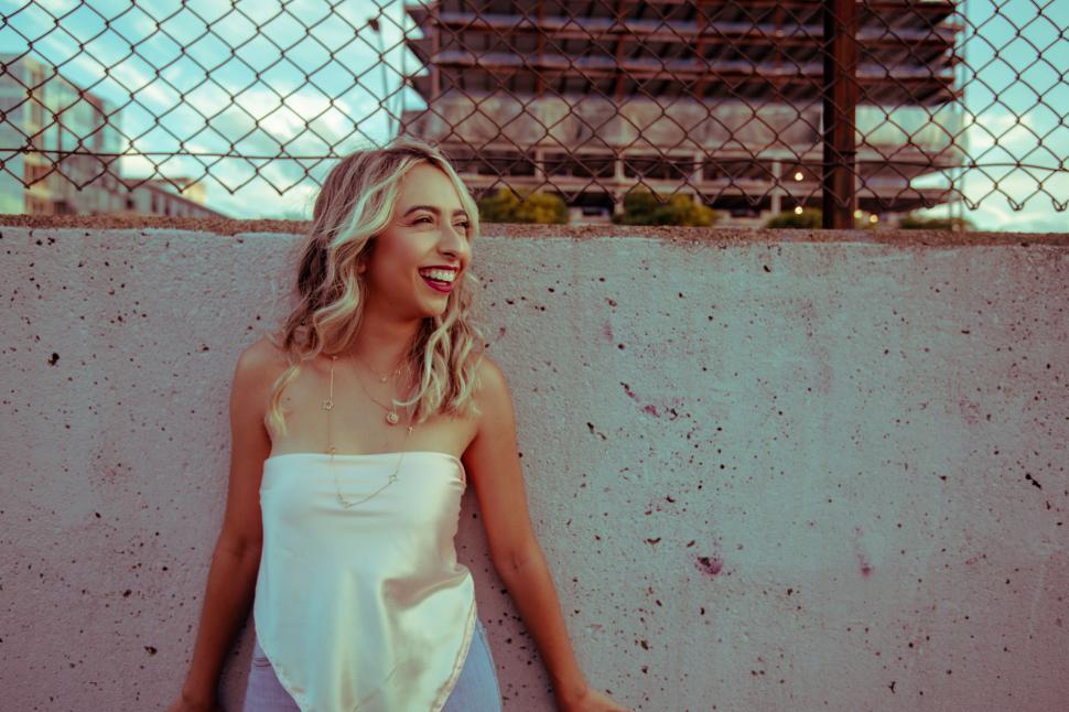 Free Image of Laughing woman against urban backdrop 