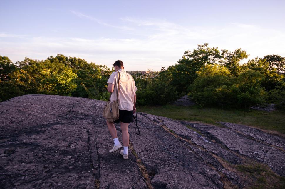 Free Image of Man exploring rocky terrain at sunset 