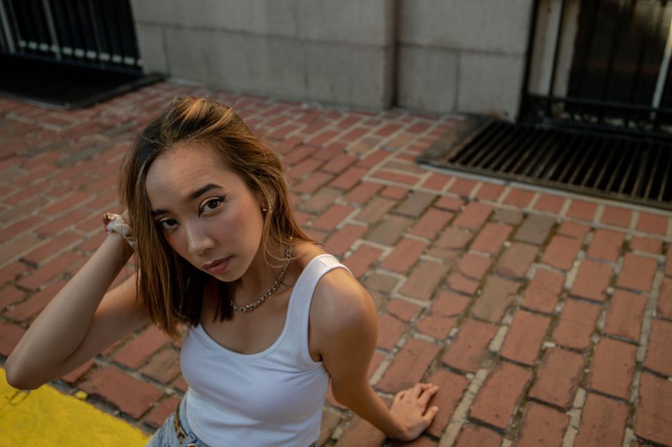 Free Image of Young woman posing on a city street 