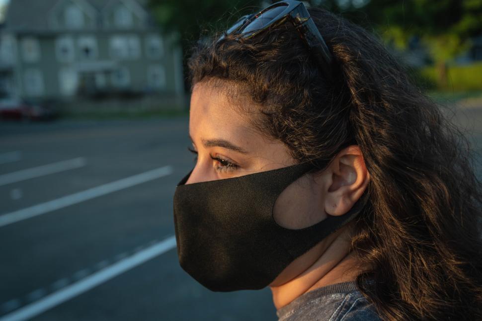 Free Image of Woman with mask in evening sunlight 