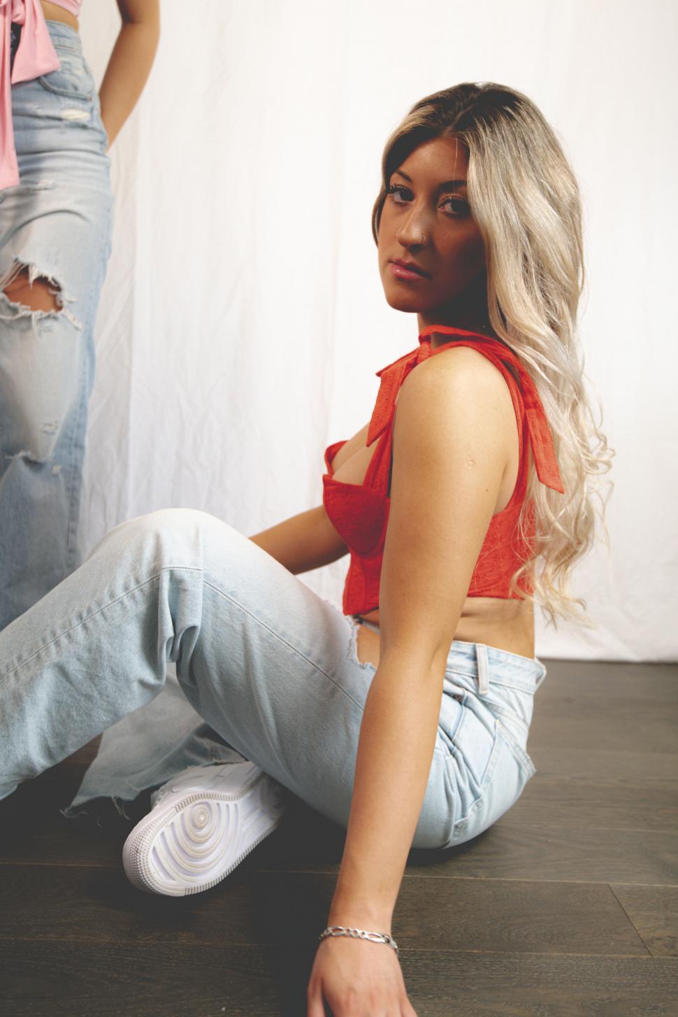 Free Image of Stylish woman in red top and denim 