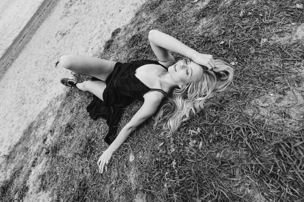 Free Image of Woman lying on grass in monochrome 