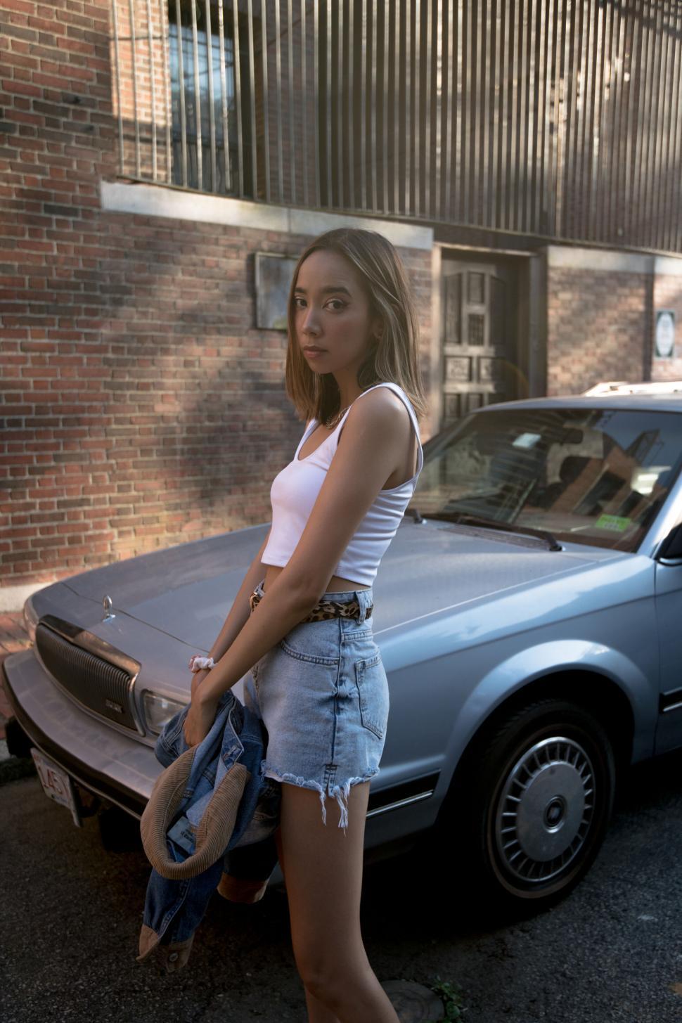 Free Image of Young woman with vintage car in urban area 
