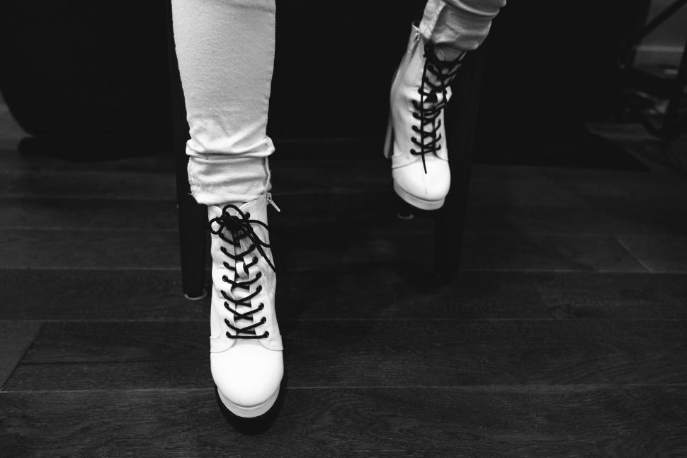 Free Image of Chic black and white boots on floor 