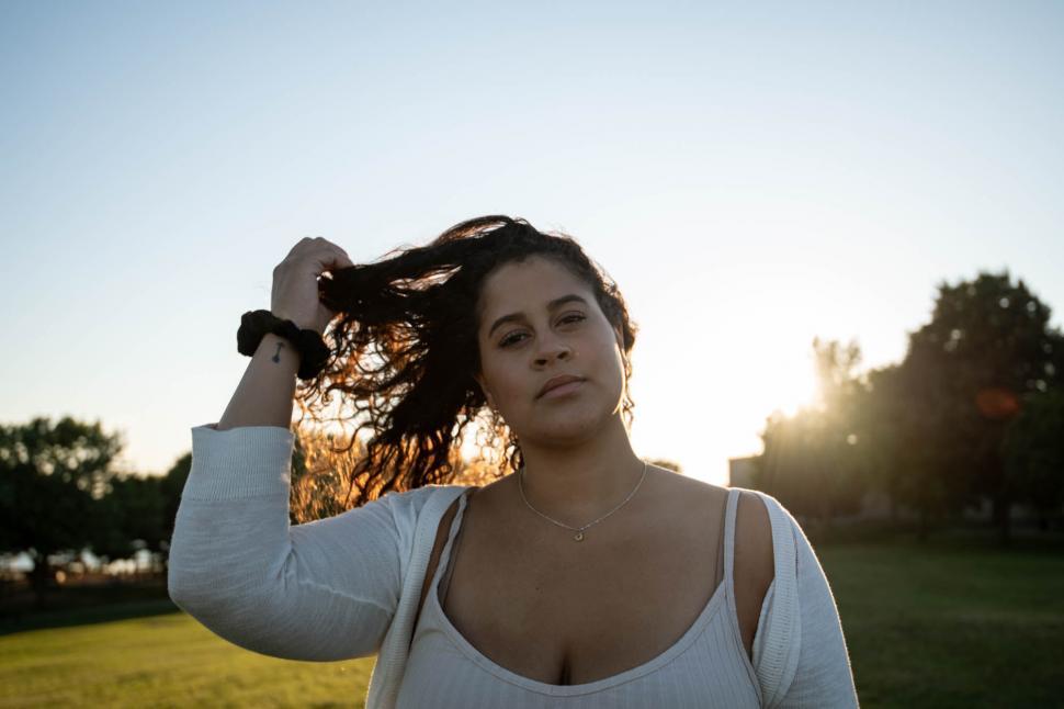 Free Image of Woman with sunset backlighting holding hair 