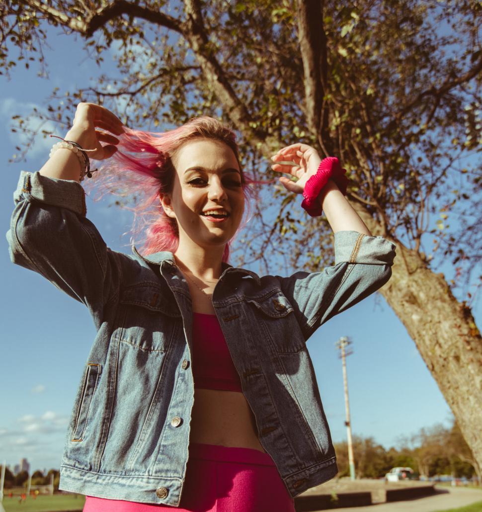 Free Image of Joyful woman with pink hair and denim 