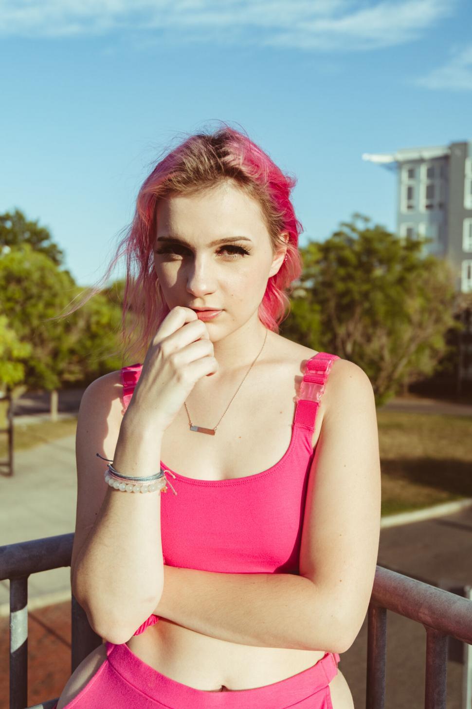 Free Image of Young woman with pink hair outdoors 