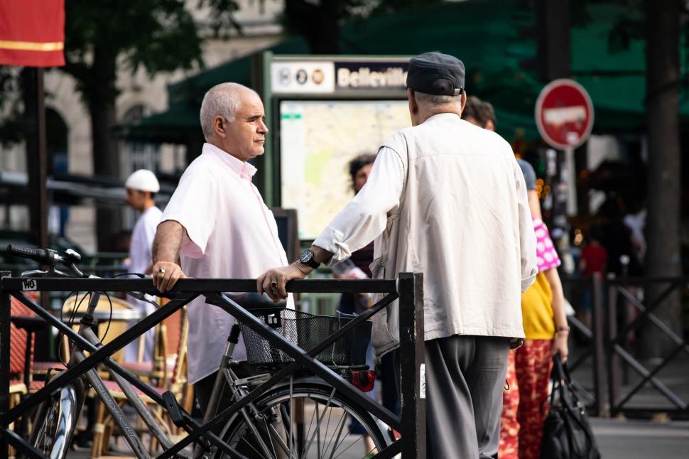 Free Image of Seniors talking near bicycle and map 