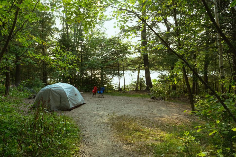 Free Image of Camping tent in a forest near a lake 