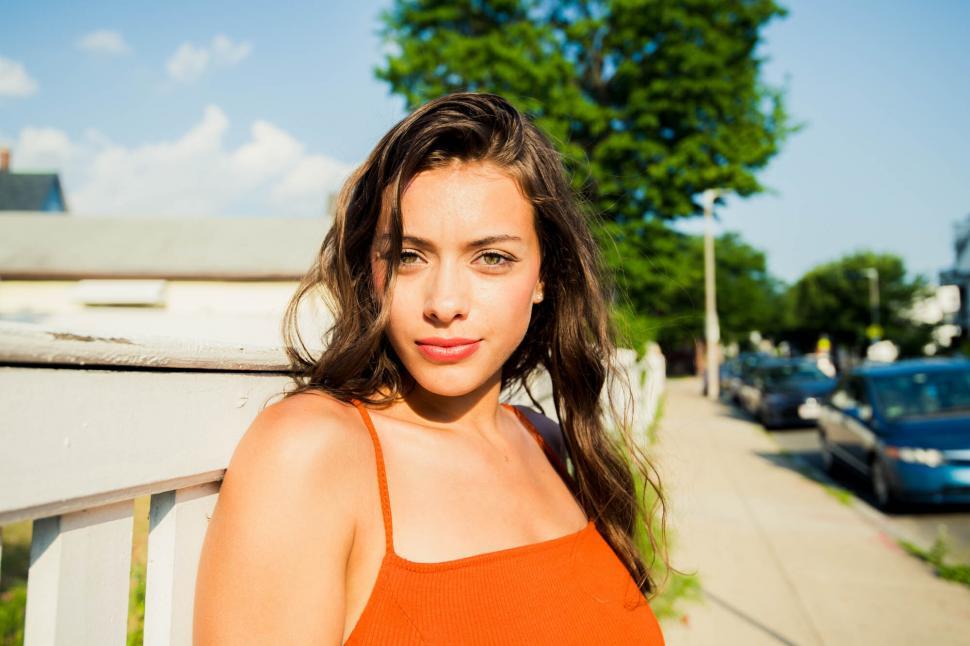 Free Image of Vibrant woman posing in a sunny urban environment 