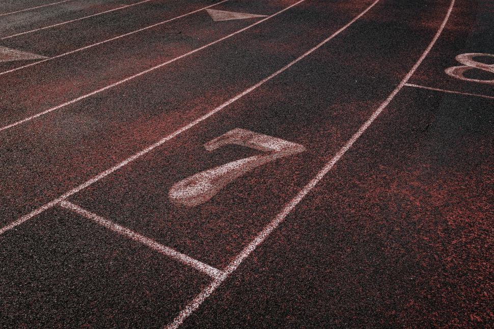 Free Image of Number seven on red running track 
