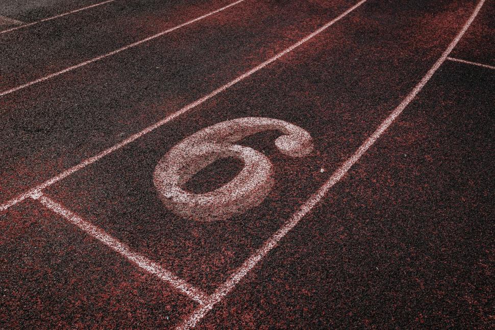 Free Image of Number 6 on red running track texture 