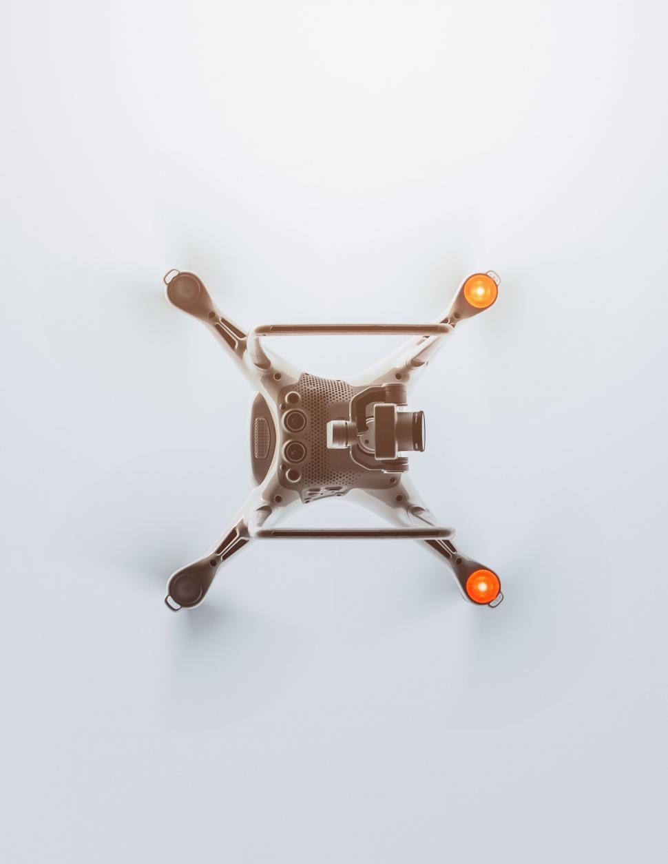 Free Image of Drone hovering in a bright clear sky 