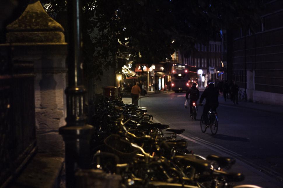 Free Image of Bicycles and nightlife in city street 
