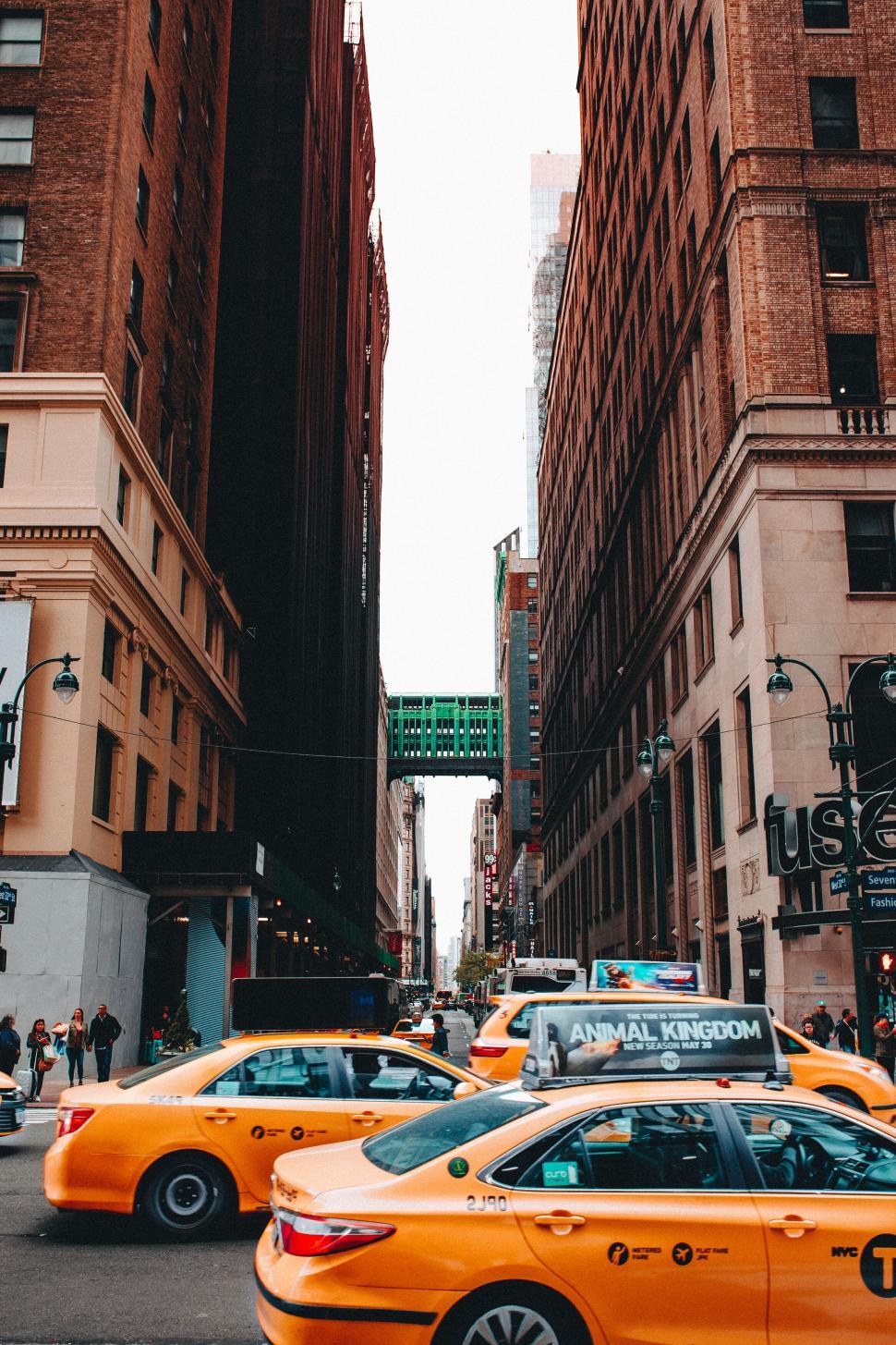 Free Image of Bustling New York street with yellow taxis 