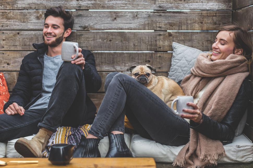 Free Image of Couple with dog enjoying coffee at home 