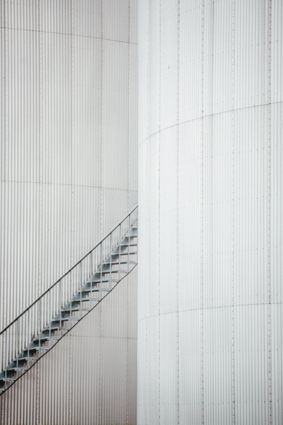 Free Image of Minimalistic white staircase against ridged wall 