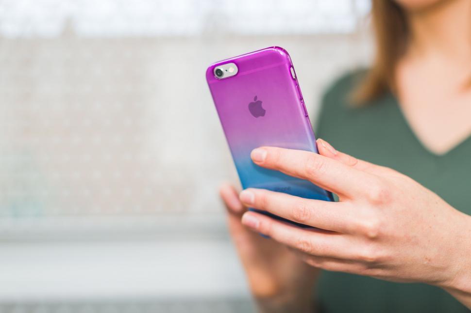 Free Image of Woman using a purple smartphone case 