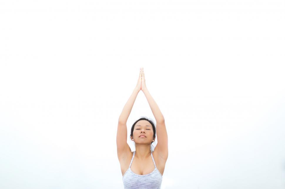 Free Image of Woman practicing yoga with raised hands 