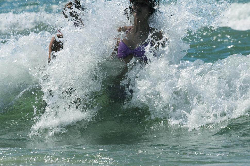 Free Image of Woman splashed by wave 