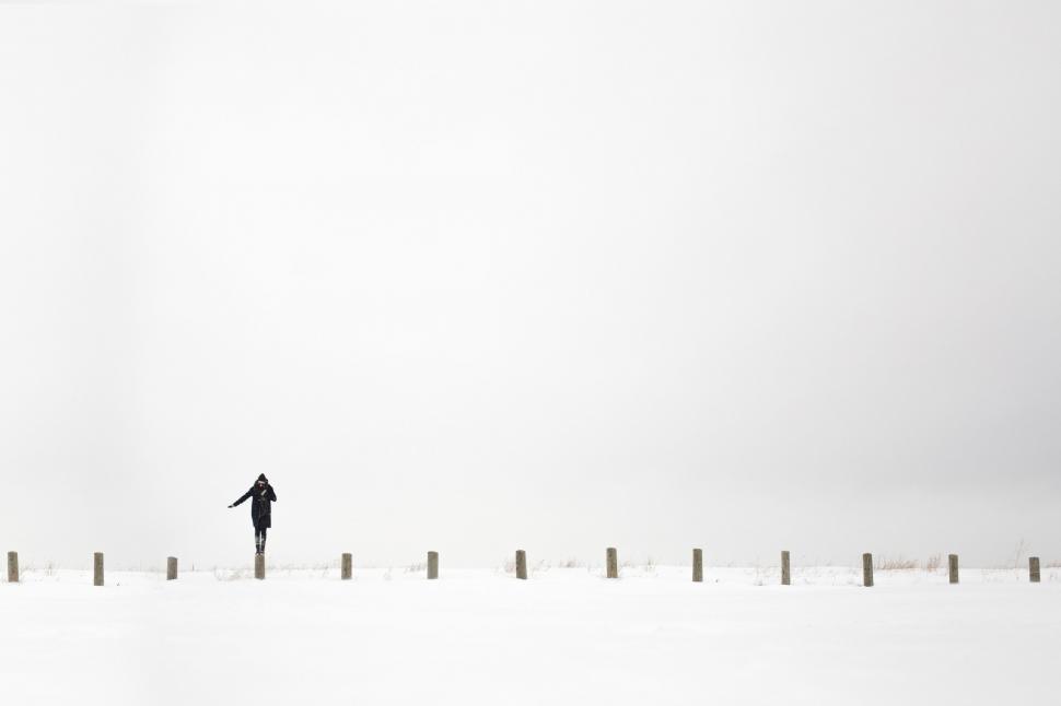 Free Image of Solitary figure in a vast snowy landscape 