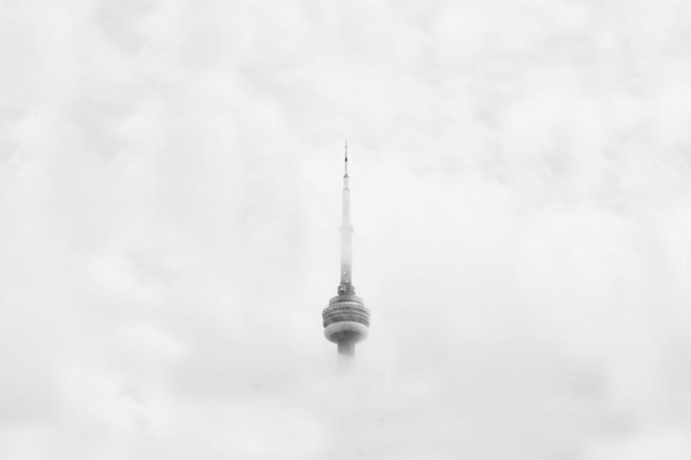 Free Image of CN Tower enveloped by foggy clouds 