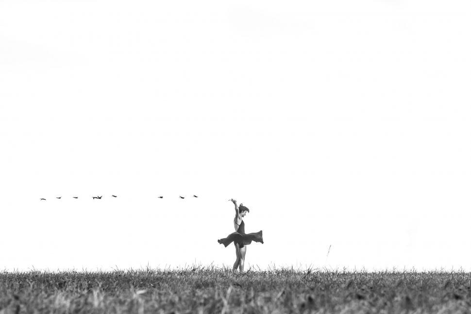 Free Image of Silhouette of person dancing in open field 